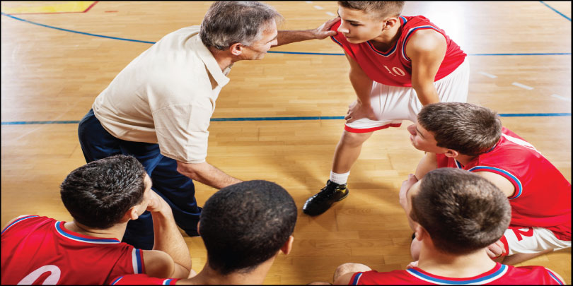 Trusted Coaches certified coach working with young basketball players